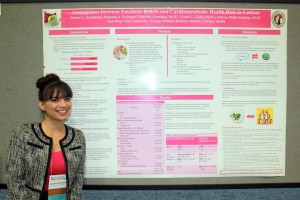 Sarinana Joanna student standing in front of poster