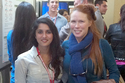 Rashmi Risbud and Dr. Jennifer Thomas standing next to SRS poster.